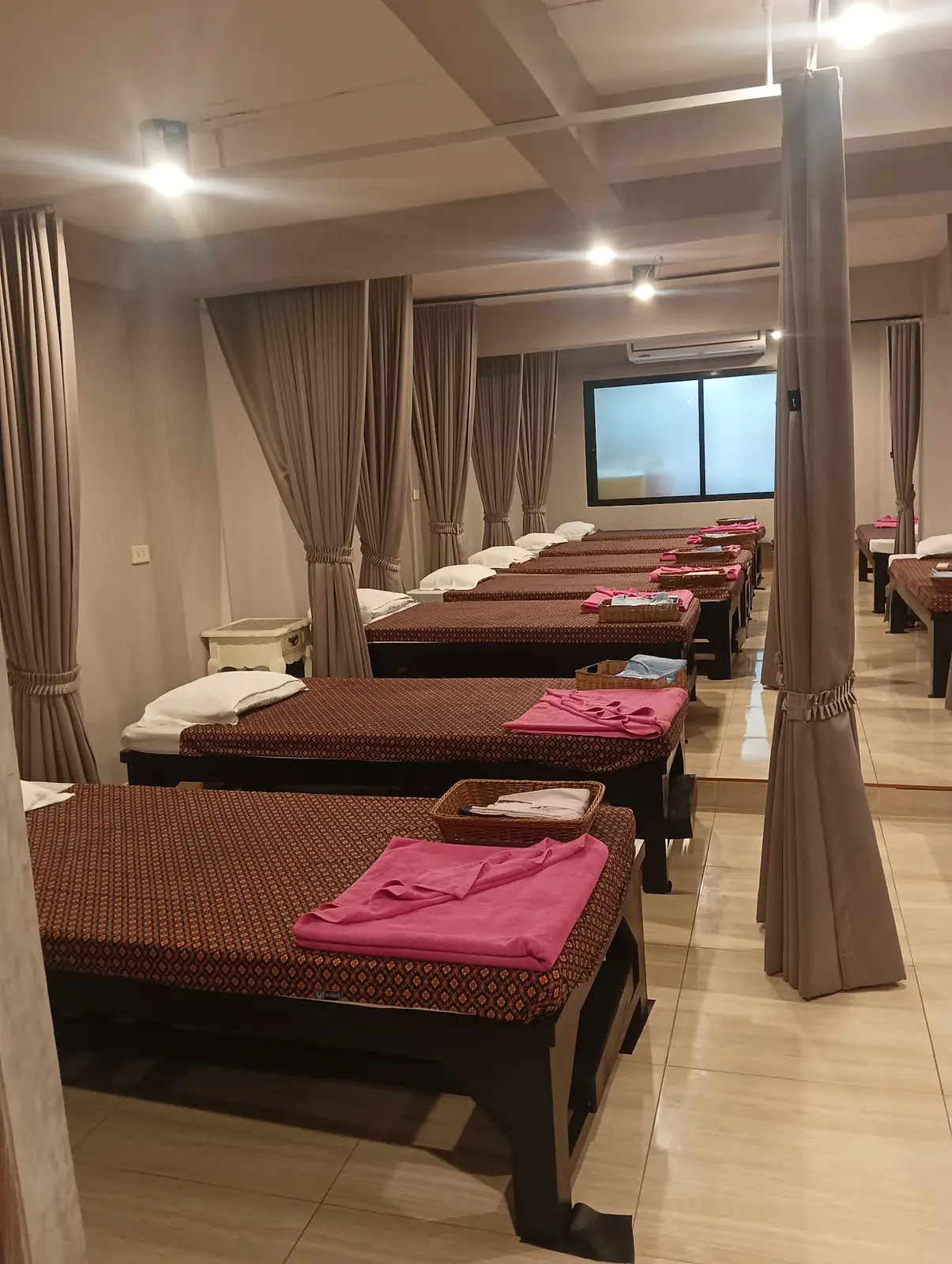 Row of curtained Thai massage beds